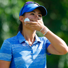 a golfer covering her mouth