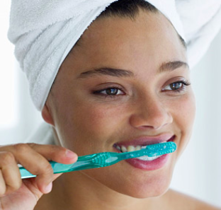 a woman brushing her teeth